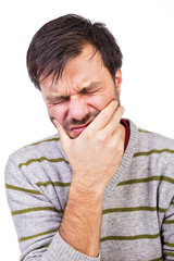 Young man suffering from a terrible tooth ache