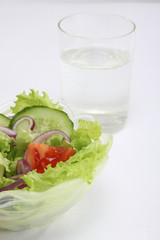 healthy food: a bowl with fresh salad, a glass of water on a