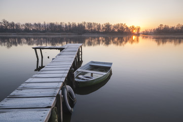 Fototapeta 	łódka zacumowana zimą do drewnianego pomostu obraz