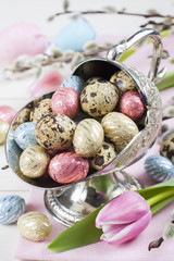 Colorful chocolate easter eggs in metal vase