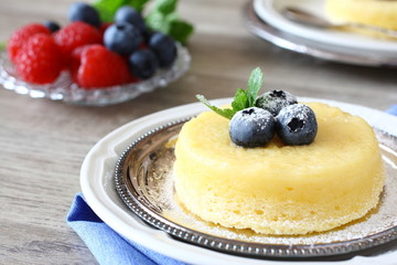 Lemon delicious pudding cake  served with berries