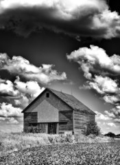 Old desolate barn with storm clouds overhead