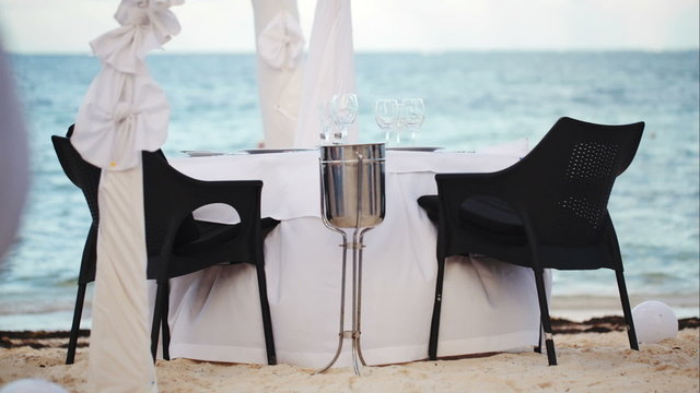 Served empty table on the shore in black and white colors