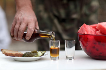 Man fills glasses of brandy
