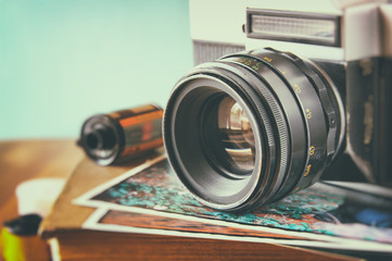 close up photo of old camera lens over wooden table. image is re