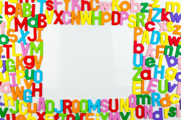 Alphabet magnets forming frame on whiteboard