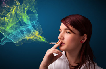 Obraz premium Pretty lady smoking cigarette with colorful smoke
