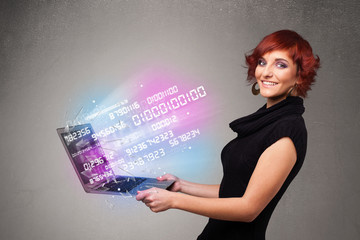 Casual woman holding laptop with exploding data and numers