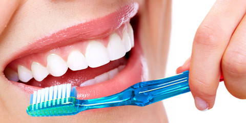 Teeth with toothbrush.