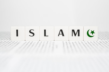Islam word block on newspaper