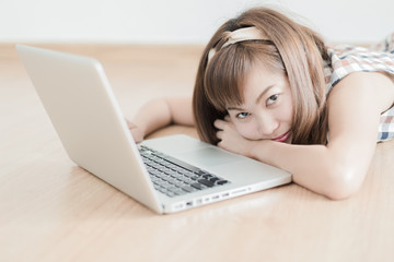 Asian woman using laptop at home