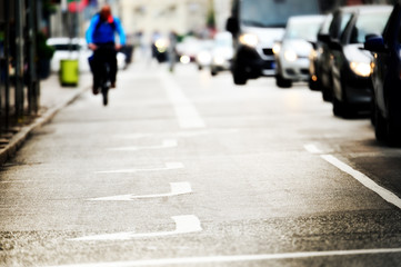 Gloomy road with arrows, bicylist distant