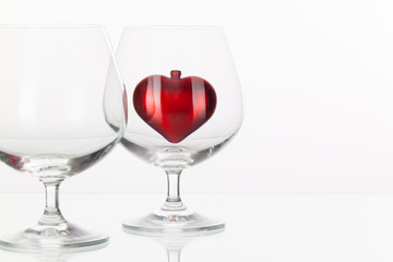 Red heart inside a glass of cognac