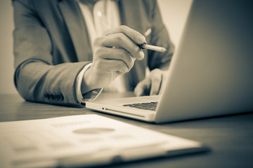 Businessman analyzing investment charts with laptop. Accounting