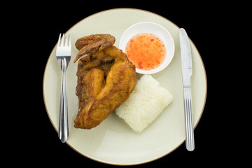 sticky rice with fried chicken , isolated on black background