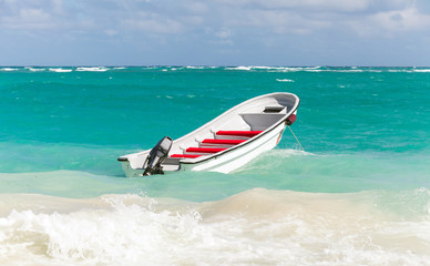 White pleasure boat floats on stormy ocean water