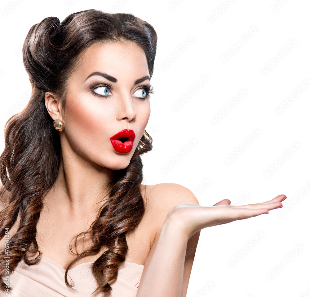 Wall mural surprised woman showing empty copy space on the open hand