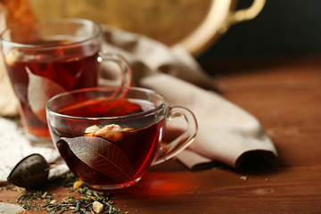 Beautiful vintage composition with herbal tea, on wooden table