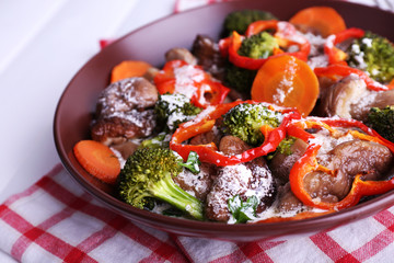 Braised wild mushrooms with vegetables and sauce in plate