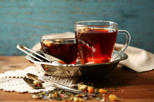 Beautiful vintage composition with herbal tea, on wooden table