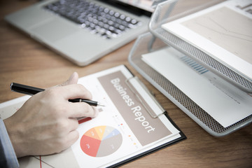 Businessman analyzing investment charts with laptop. Accounting