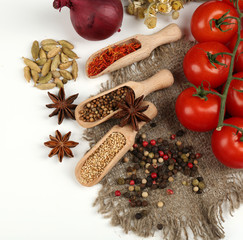 Different spices and herbs in wooden spoons isolated on white