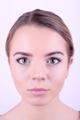 Fototapeta premium Applying makeup on female face, isolated on white background