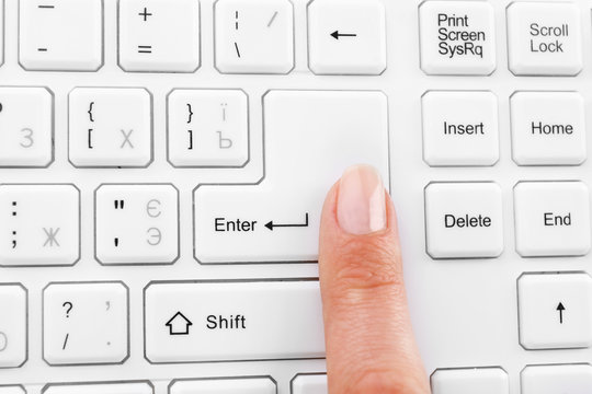 Female finger typing on keyboard, macro view
