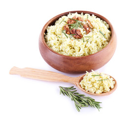 Rice with walnuts and rosemary in plate isolated on white