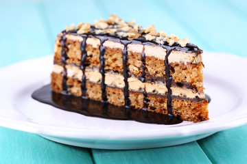 Delicious chocolate cake on plate on table close-up