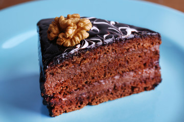 Delicious chocolate cake on plate on table close-up