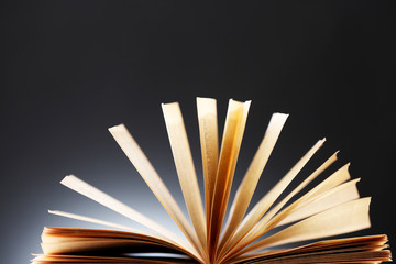 Open book over dark colorful background