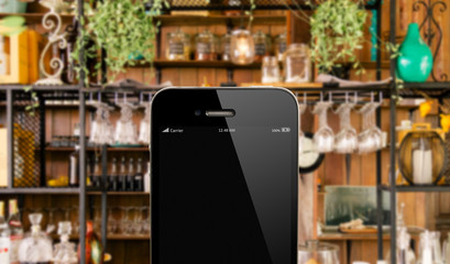 close up smart phone against beautiful  kitchen background