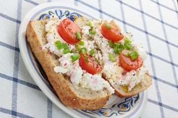 Cottage cheese with radish, chives and cherry tomatoes.