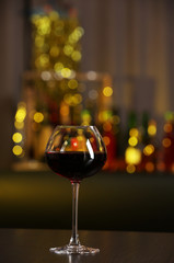 Glass of red wine in bar on blurred background