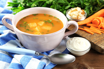 Composition with carrot soup, ingredients and herbs