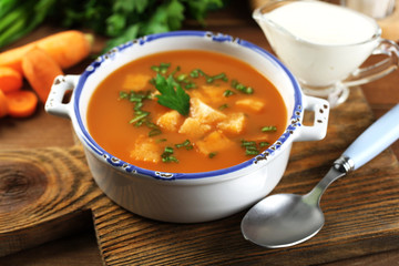 Composition with carrot soup, ingredients and herbs
