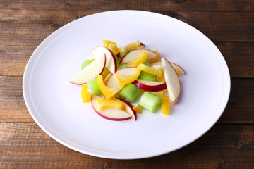 Waldorf salad with salad pepper on plate on wooden background