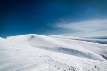 Fototapeta na wymiar A large snow-covered fields under the sun