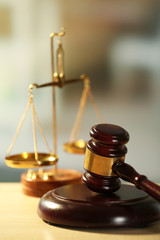 Wooden judges gavel on wooden table, close up