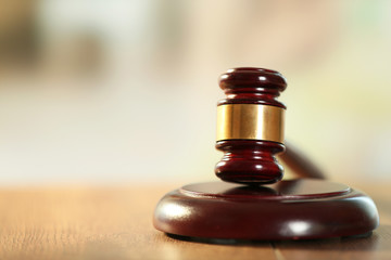 Wooden judges gavel on wooden table, close up