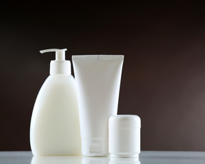 Group of cosmetic bottles on dark background