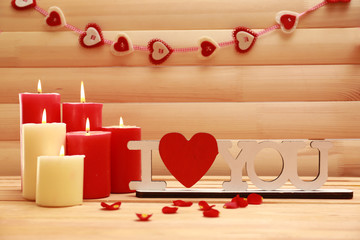 Romantic candles on wooden background, love concept