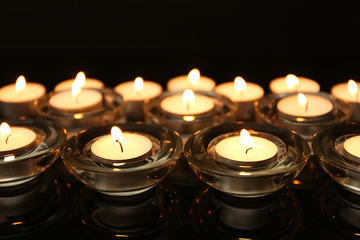 Burning candles on dark background