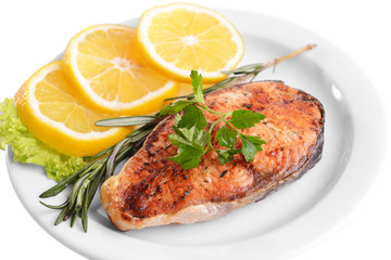 Tasty baked fish on plate isolated on white