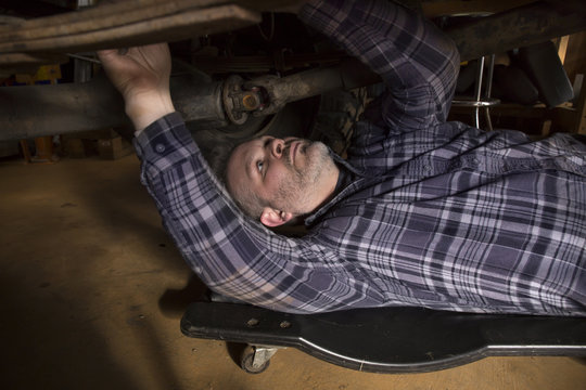 Man under car doing mechanic work