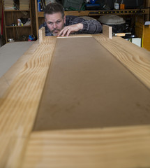 Man measuring woodworking project