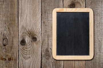 Blackboard on old wooden background