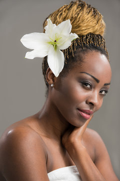 Sensual African woman lily flower in hair