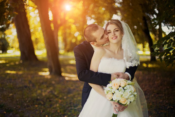 Elegant bride and groom posing together outdoors on a wedding da